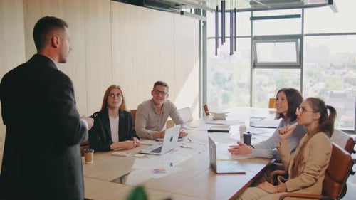 Diverse Group of Professionals Meeting in a Modern Office for a Collaborative Session to Enhance