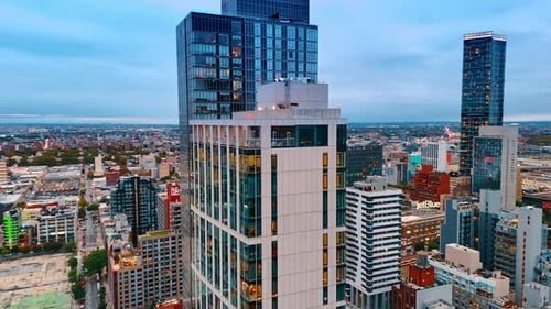 Drone footage around the high-rise buildings of modern design.