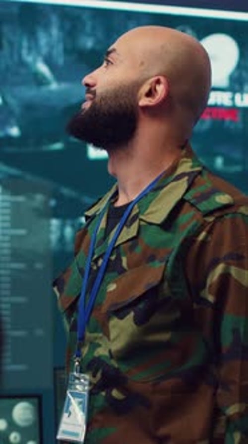 Man in Camo Uniform Looking at Screen