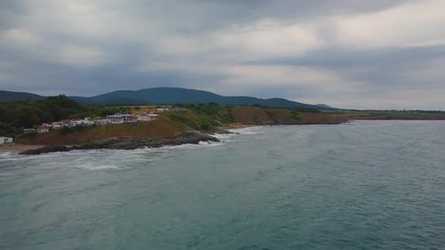 Drone flying above sea to the beach in winter
