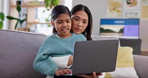 Mother and Child Using Laptop Together at Home