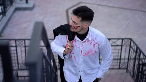Man with Fake Blood and Wound Makeup on Stairway