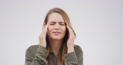 Woman Rubbing Temples in Discomfort