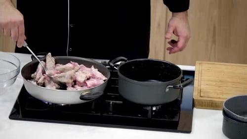 Chef Cooking Pork in Bright Kitchen