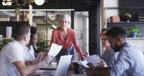 Business people, meeting paperwork and mature woman discussion on company finance