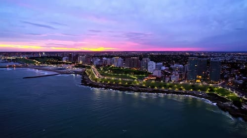 Rising Panoramic Aerial over Mar Del Plata City Waterfront at Vibrant Sunset