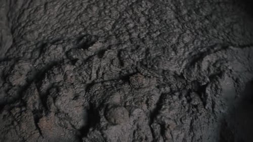 Concrete is Mixed in a Close Up Concrete Mixer