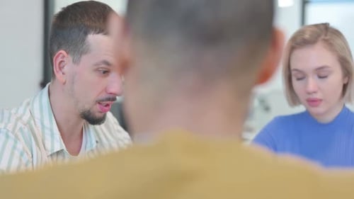 Close up of Creative People Talking during Meeting