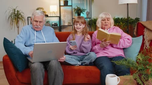 Grandparents with Grandchild Using Modern Technology