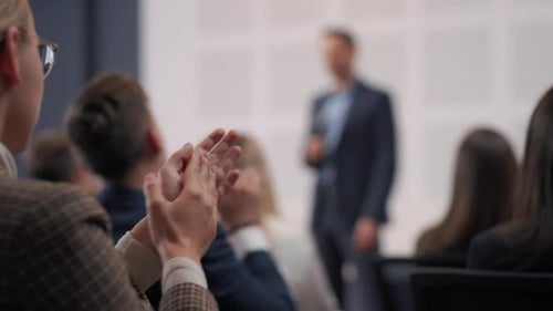 Corporate Presentation: Audience Applauding Speaker at Conference