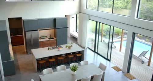 Modern kitchen and dining area with large table and stylish chairs, copy space