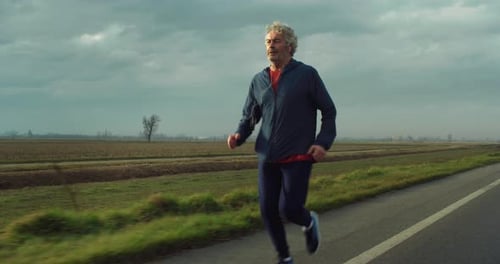 Adult Jogging on a Rural Roadway