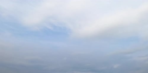 Dense cloudscape spreading around the sky. Grey clouds and rain formation from low angle view.