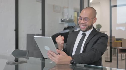Young Adult Man Celebrating Business Success in Office