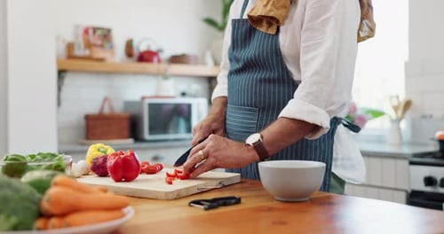Person Chopping Fresh Vegetables in Kitchen