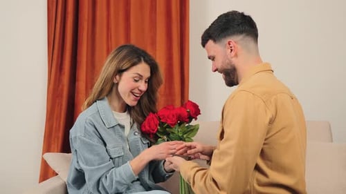 Man Proposes with Roses to Woman in Home