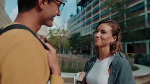 Close up of two friends, European male and female students in casual clothes talking