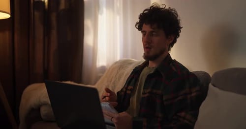 Young Adult Working on Laptop at Home