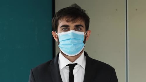 Young Adult in Suit with Surgical Mask Close Up