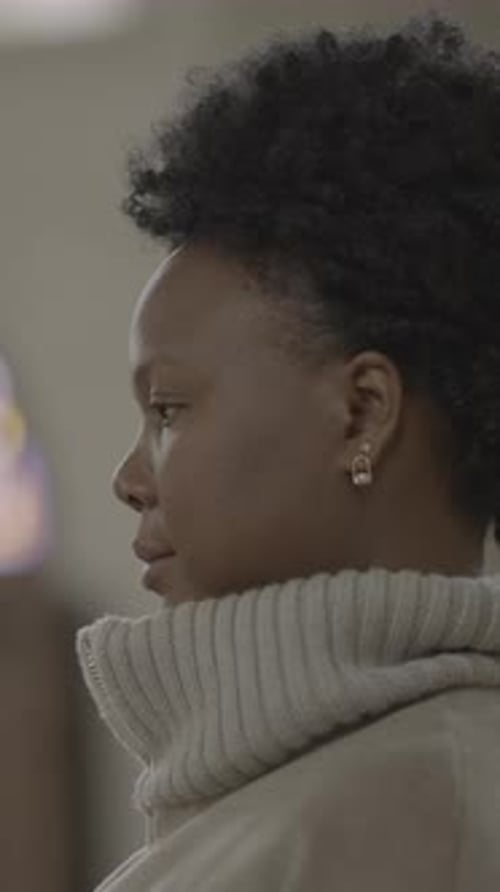 Woman with Textured Hair Looking off with a Smile