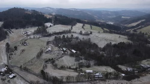 A flight over the countryside with a path leading through the trees and a view of the surrounding th