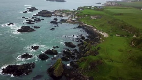 Cinematic downward aerial view of rocky coastline in northern Ireland