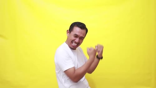 Man Cheering with Excitement on a Yellow Background
