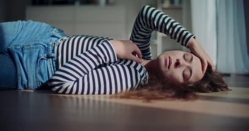Woman Lying on Floor in Bright Sunlight