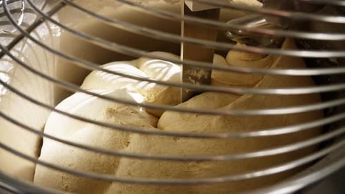 A Dough Mixer Kneads Dough in a Bakery for Baking