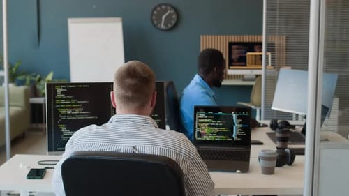 Two Men Working In IT Company Office