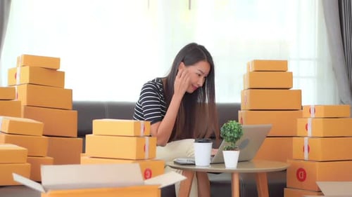 Selling Online Concept Happy Asian Woman Checking Orders in Her Online Shop With Laptop With Room Fu