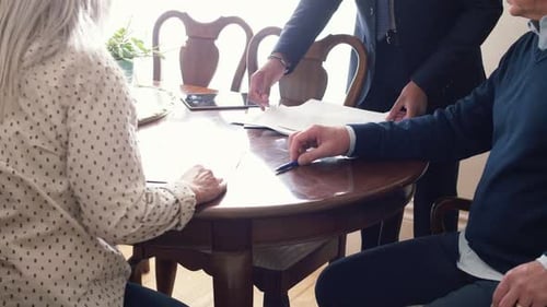 Financial advisor meeting with senior couple at home