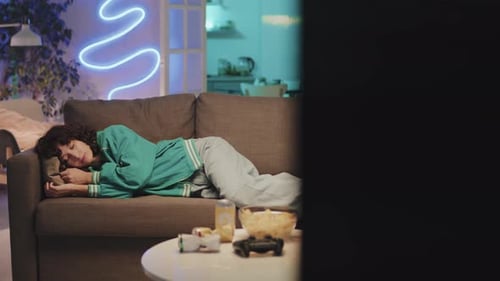 Young Adult Woman Asleep on Couch Indoors