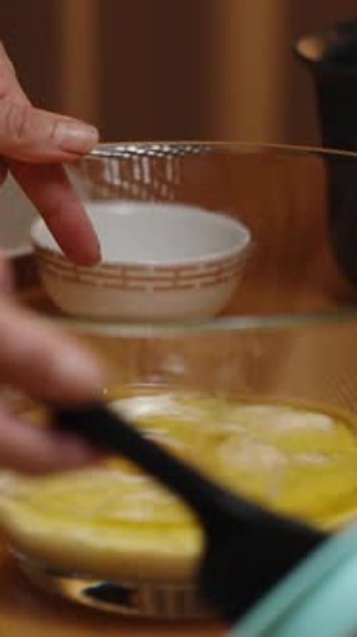 Vertical video. Two cracked eggs are being mixed together with the banana puree.