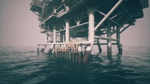 Oil Platform Standing in Calm Waters Off the Coast During the Early Morning