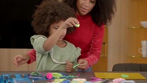 Joyful School Age African American Girl and Mother Playing with Toy From Playdough