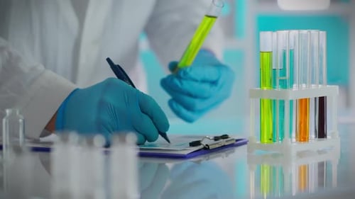 Scientist Analyzing Samples in Lab Test Tubes