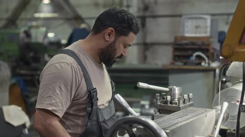 Male Engineer Working on Machinery Equipment at Metalworks Plant