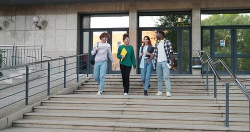 Group of Diverse College Students Talking to Each Other and Walking on Campus