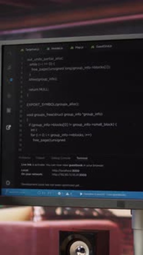Vertical Video Code Editor on PC Display Used to Build Applications in Cozy Bright Living Room
