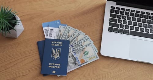 Ukraine Passport, Tickets, Money, and Laptop Top-Down