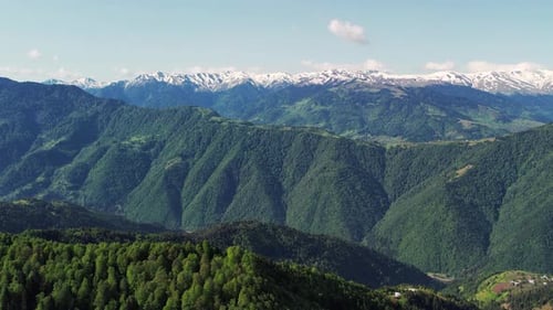 Verdant Mountain Range with Snow Capped Peaks