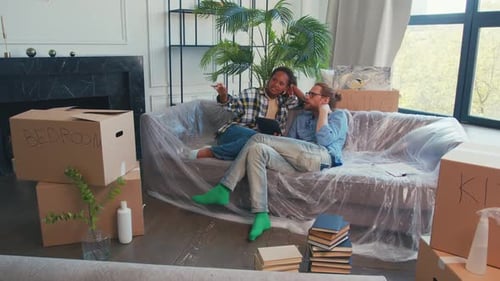 Couple Relaxing on Couch in New Home