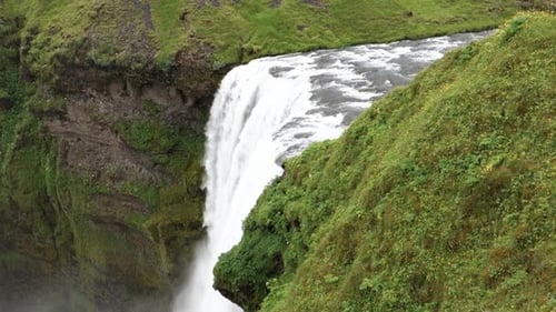 Landscape of Skogafoss waterfall from a neigbouring hill in Iceland