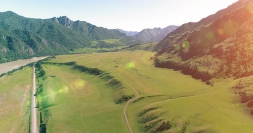Aerial Rural Mountain Road and Meadow at Sunny Summer Morning Asphalt Highway and River