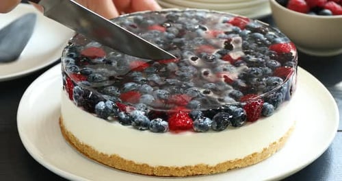 Berry Cheesecake with Gelatin Topping being Cut