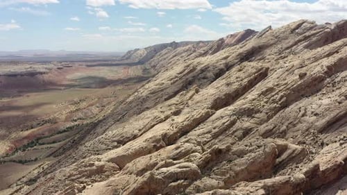 Majestic aerial view of rocky cliffs under clear skies at noon