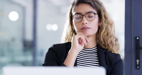 4k video footage of an attractive young businesswoman working in an office