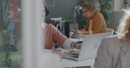 Professionals Working Diligently in Modern Office