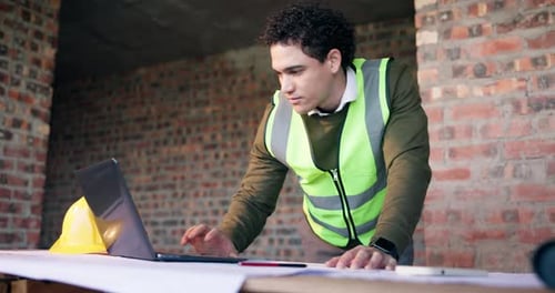 Man, laptop and blueprint on construction site for infrastructure, inspection or update planning